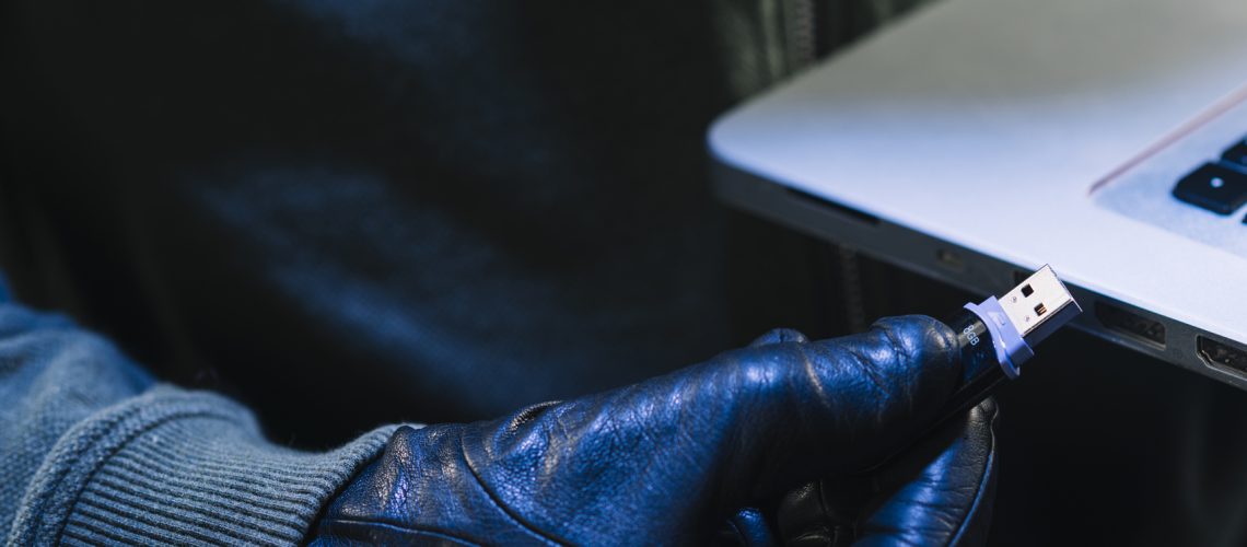close-up-hacker-with-usb-stick